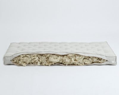 Home of Wool crib mattress with open zipper - detail on the wool filling